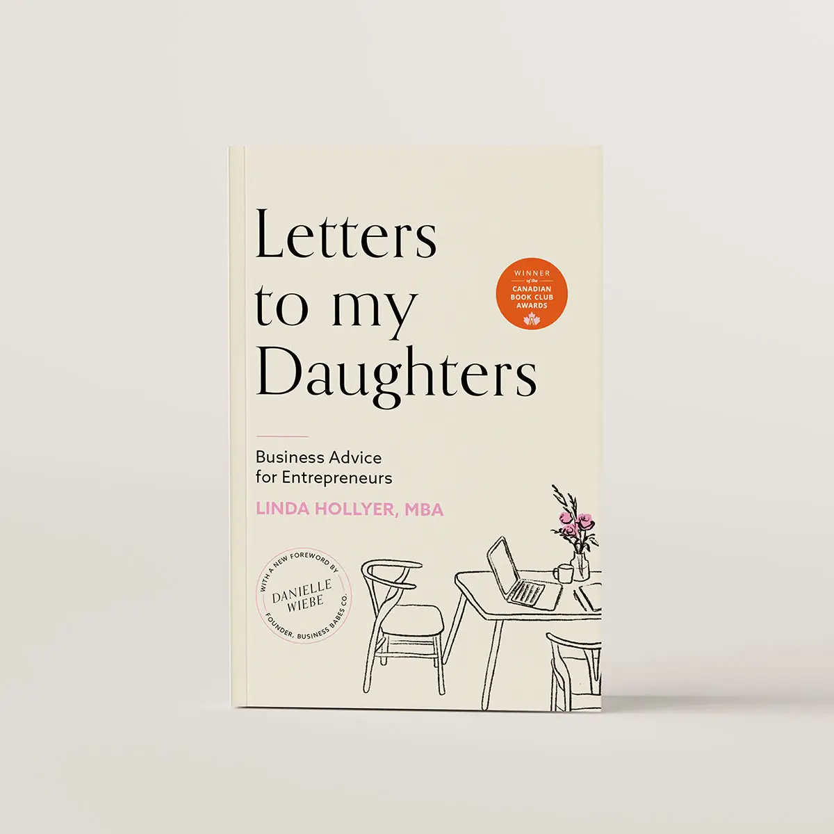 Book cover of Letters to my Daughters to Linda Hollyer. The cover is cream with a black line drawing of a desk and chairs with a laptop on it and a vase of flowers.