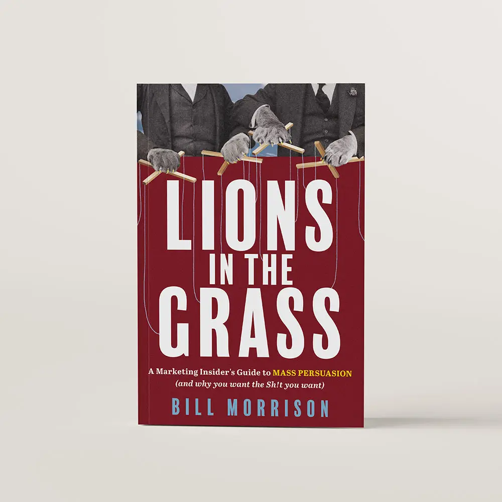 Book cover of Lions in the Grass by Bill Morrison. There are two business men at the top of the cover with lions paws for hands, holding the wooden sticks of puppeteer. The strings of the puppet are attached to the letters of the title as if the letters are the puppets. 