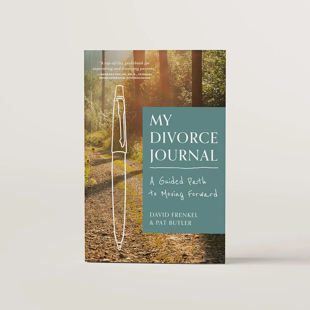 Book cover for My Divorce Journal. The cover features a photo of an open path through the woods with sunlight trickling down. Theres an outline of a pen drawn on top of the photo.