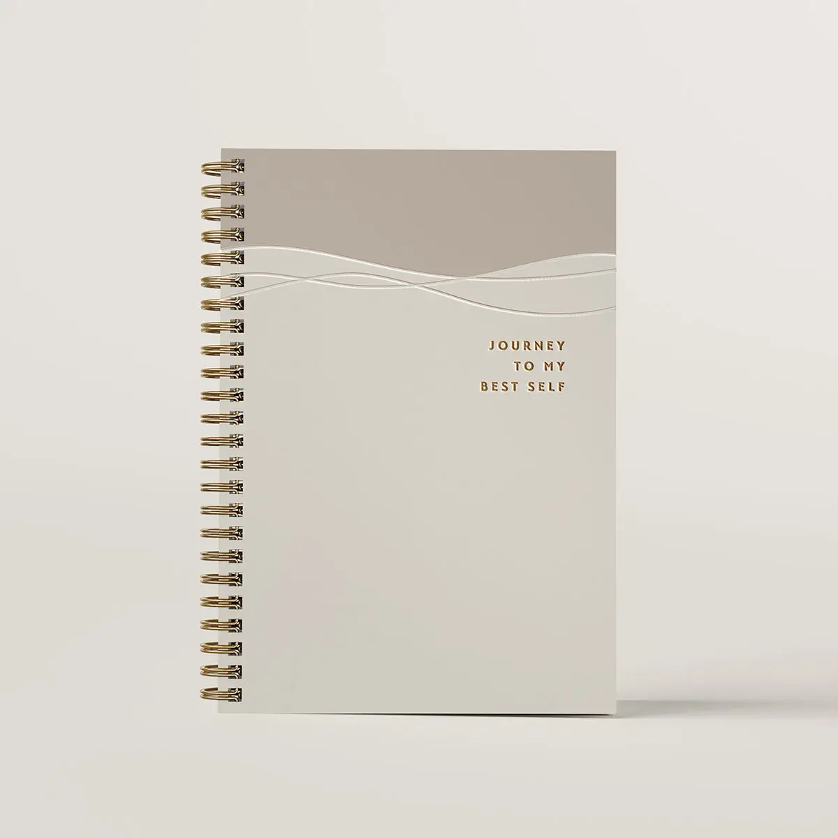 Journal design of Journey to My Best Self. It's beige cover with 2 flowing lines that are debossed, and a smalll debossed title.