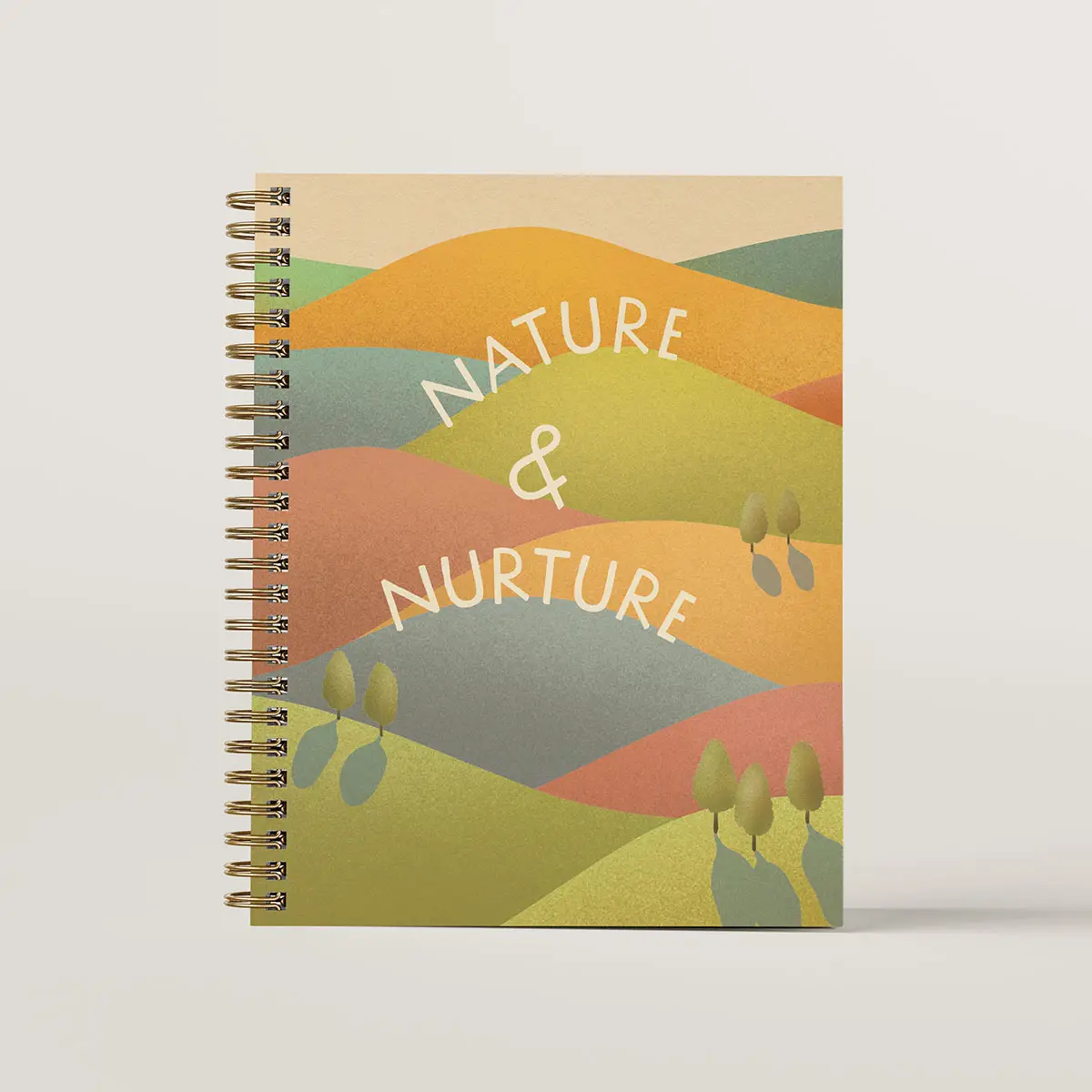 Journal cover design of Nature & Nurture. The cover is illustrated with rolling hills in greens and warm tones and with small trees on the hills with long cast shadows.